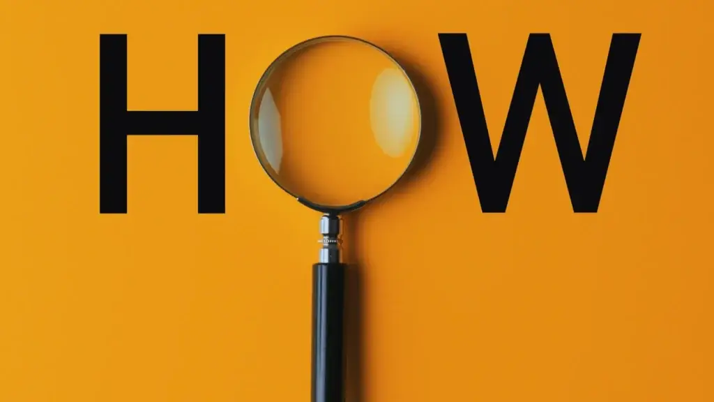 Magnifying glass on a bright orange background focusing on the letter 'O' of the word 'HOW,' representing detailed examination and analysis in a 'How-to' guide for project success