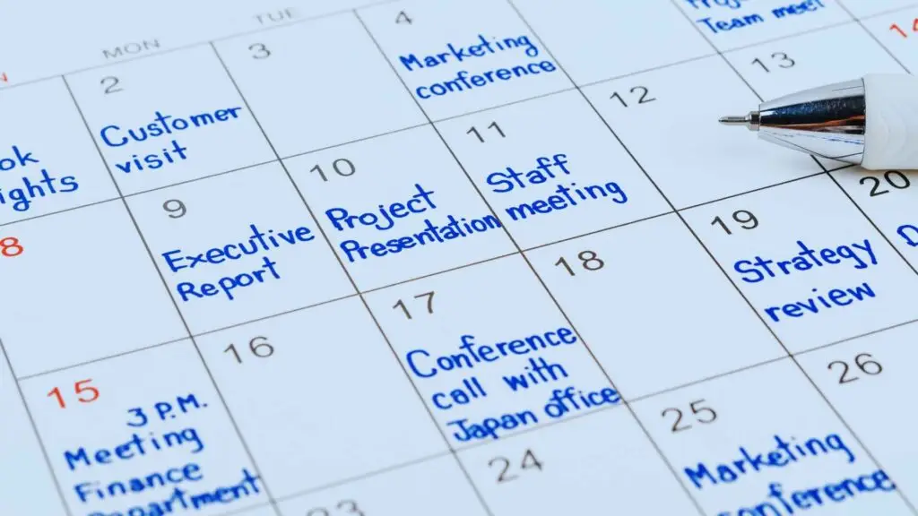 Detailed office calendar highlighting key business events including marketing conference, project presentation, and staff meetings.