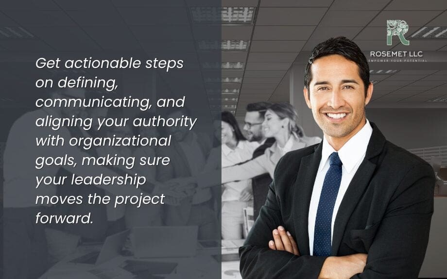 A confident person in a suit smiles with arms crossed, standing in an office. A blurred team is in the background. Text beside them reads: "Get actionable steps on defining, communicating, and aligning your authority in project management with organizational goals...