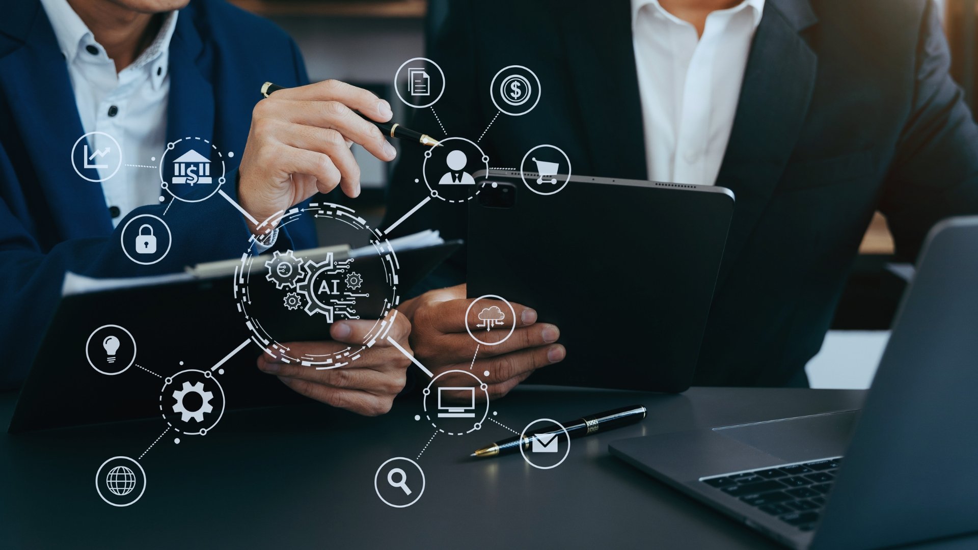 Two people in business suits discuss data at a desk with a tablet and laptop, overlaid with digital icons representing technology concepts like AI, cloud computing, and online security—highlighting key goals for change management.