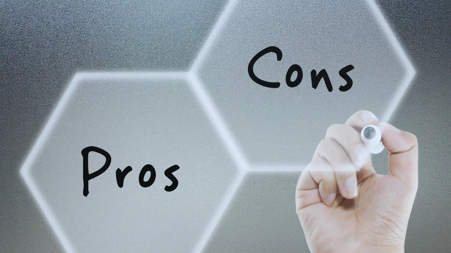 A hand writes "Cons" with a marker on a frosted hexagonal glass surface beside "Pros," already in another hexagon. The light, blurred background hints at a brainstorming session—ideal for discussing the Gantt Chart for Agile Methodology.