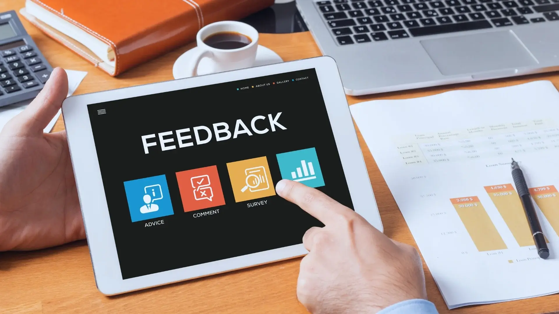 A person holds a tablet displaying "FEEDBACK" with options for advice, comment, survey, and statistics—emphasizing value-driven delivery. A laptop, papers with charts, and office supplies are spread out on the wooden desk.