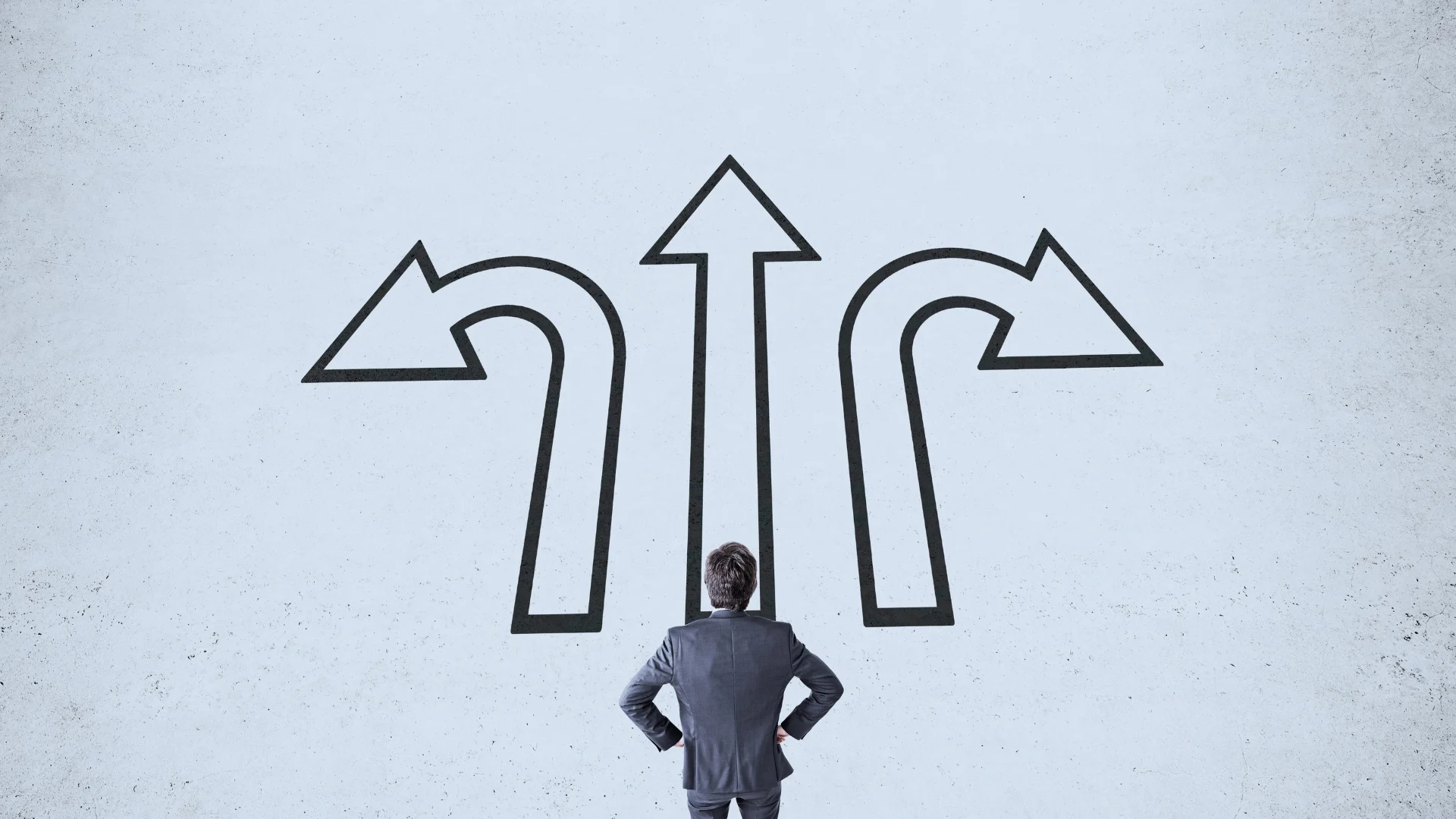 A person in a suit stands facing a wall with three large black arrows pointing left, straight, and right—symbolizing the challenge of choosing a BVDash alternative.