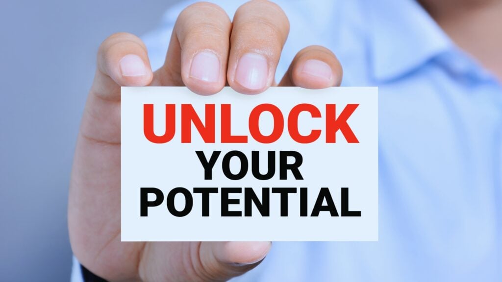 A person in a blue shirt holds a card that reads "UNLOCK YOUR POTENTIAL" in bold red and black letters, inviting you to discover new opportunities with SmartSuite Sign-Up.