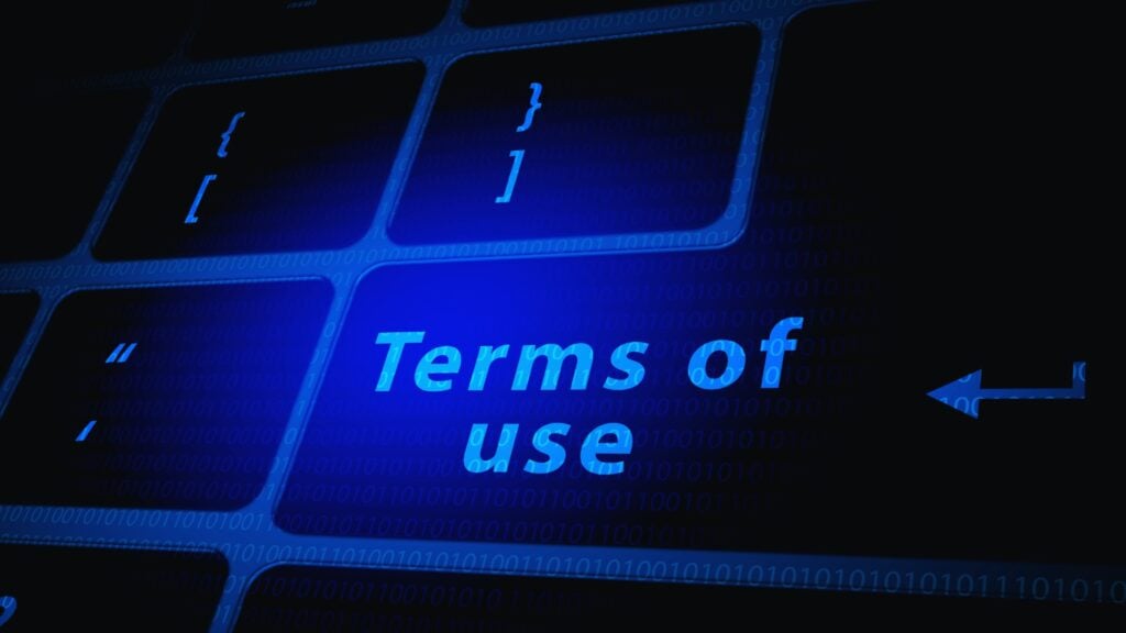 A close-up of a computer keyboard with the SmartSuite App highlighted in blue text on one key, featuring "Terms of use" and surrounded by other keys and binary code in the background.