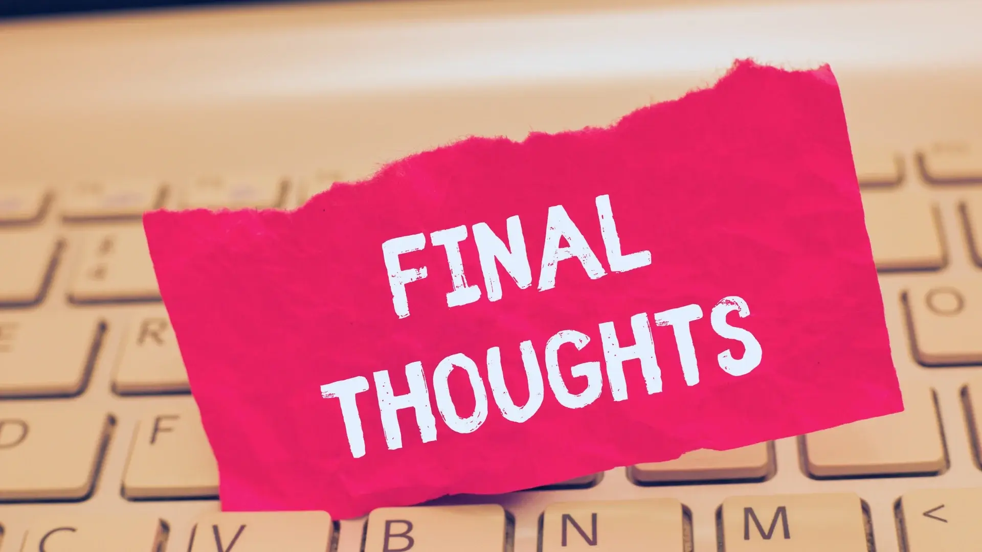 A torn pink paper with the words "FINAL THOUGHTS" in bold white letters is placed on top of a beige computer keyboard, sparking reflection on topics like what is agile environment and modern work practices.