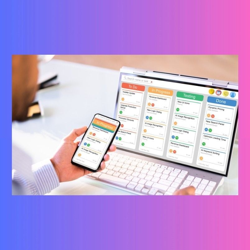 A person uses a smartphone and laptop, both showing a digital task board with To Do, In Progress, Testing, and Done columns—a perfect scene for Project Management Software for Small Businesses. The background has a gradient of purple and pink.