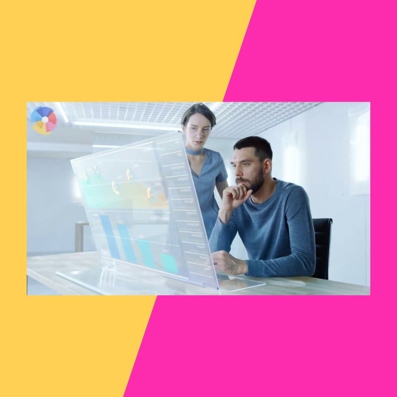 Two people in a bright office focus intently on a transparent screen showing data and charts about Project Deadlines in BVDash. The photo features a diagonal split background of yellow and pink.