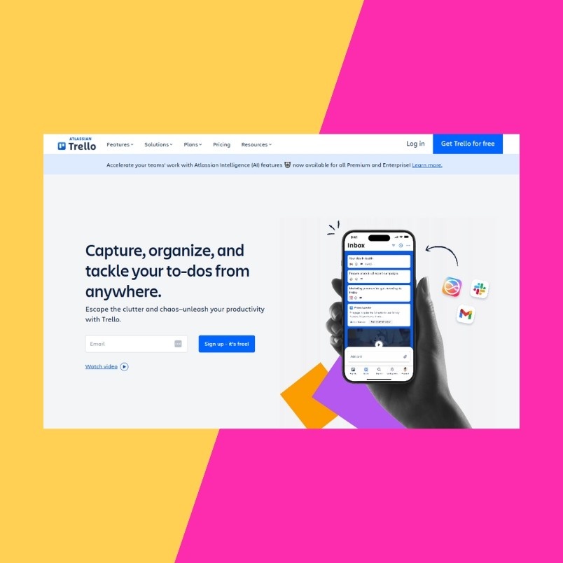Screenshot of Trello’s homepage highlighting to-do organization and project management workflow, featuring a hand holding a phone with the Trello app against a vibrant yellow and pink diagonal background.