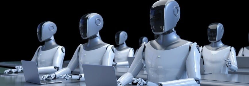 A row of humanoid robots sits at desks, working on laptops in a classroom or office setting, illustrating the impact of AI in project management against a dark background.