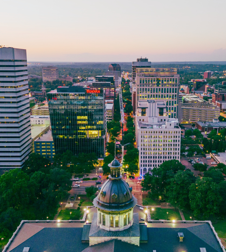 Aerial twilight view of the Columbia, SC skyline where ROSEMET provides on-demand project management coaching and live office hours.
