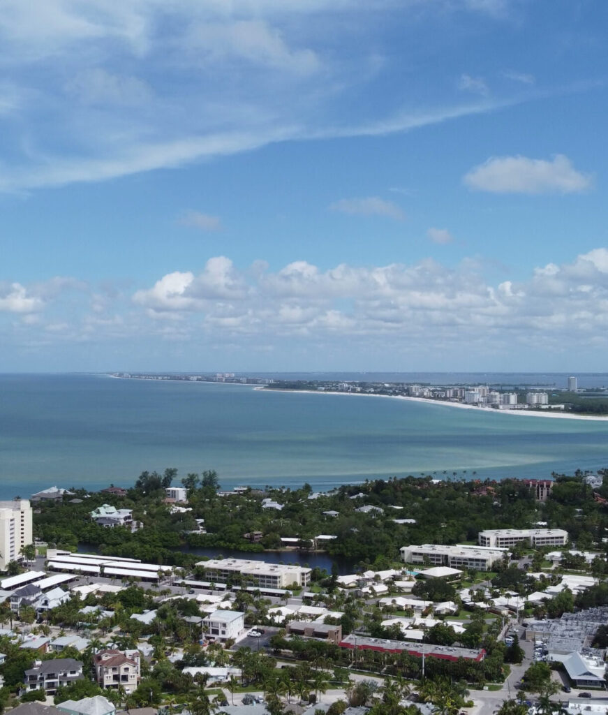 Aerial view of Sarasota beach and coastal cityscape; start PMP® or CAPM® training with free 7-day access, live office hours, and 1-on-1 coaching.